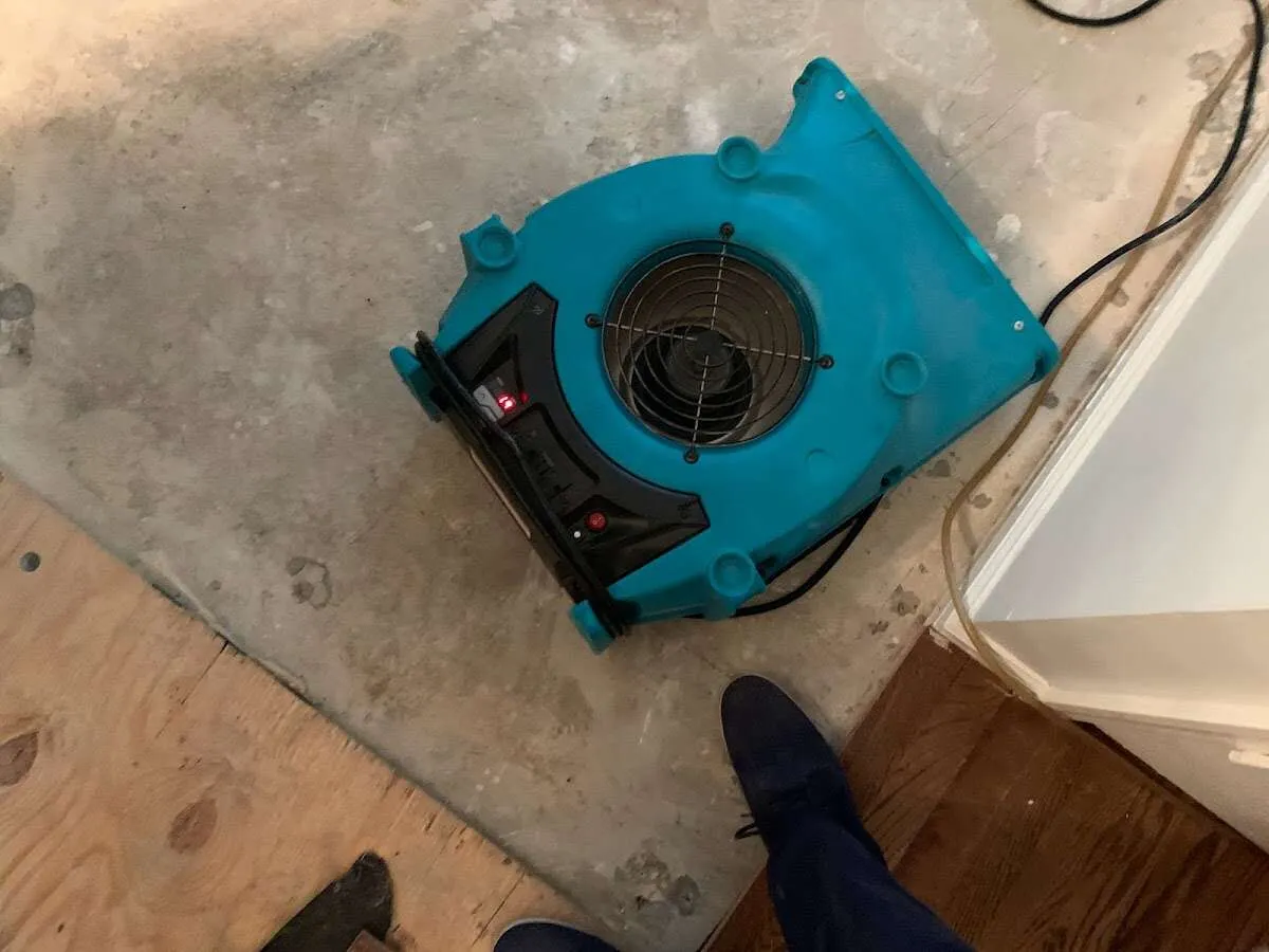 Air mover drying subfloor during Leak Detection & Repair in Stanford